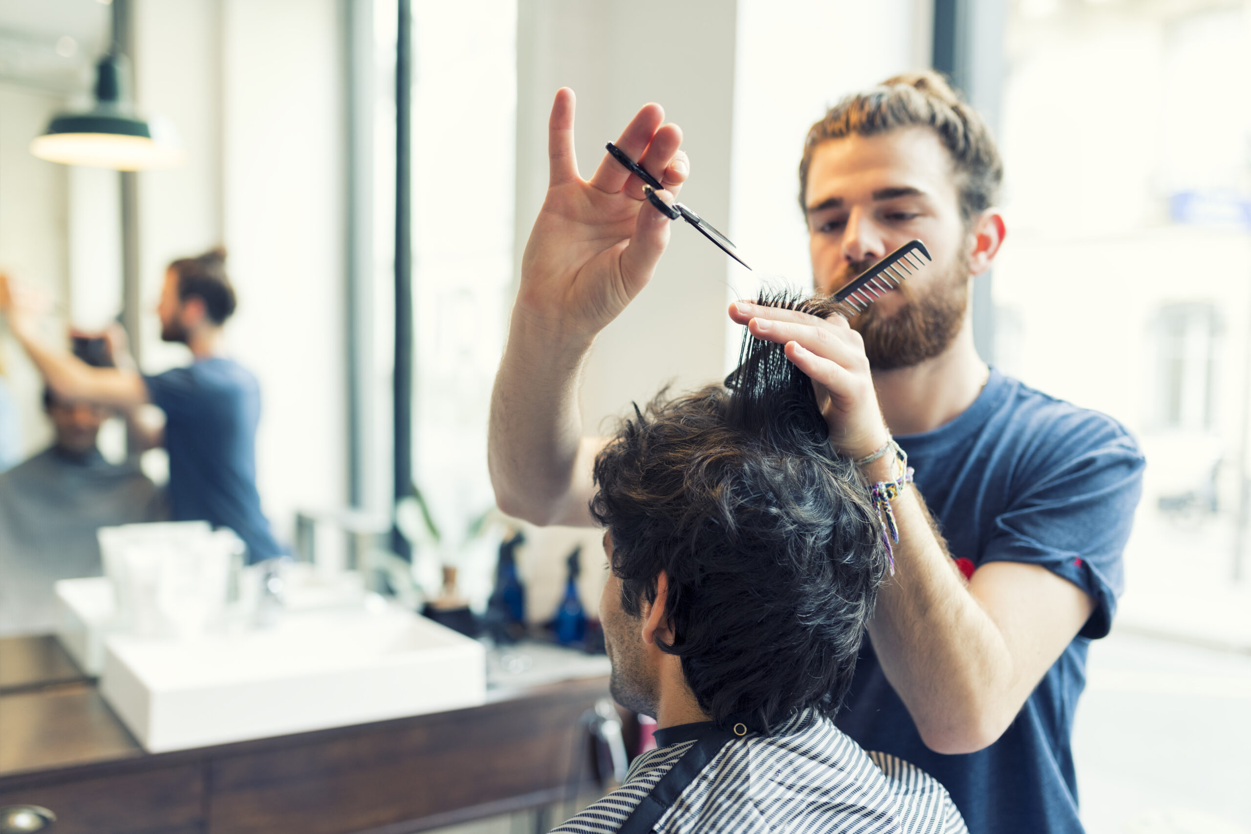 Man gets a haircut at his barber